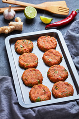 raw thai fish cakes on a baking sheet
