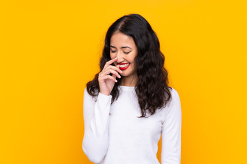Fototapeta premium Mixed race woman over isolated yellow background laughing