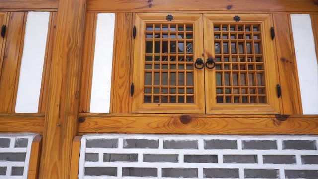 Traditional korean house Hanok in downtown old city of Seoul details of wood window and brick wall
