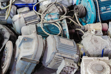 Old motor laid on the floor. The old motor is scrapped. Rusty old motor. Old electric cable