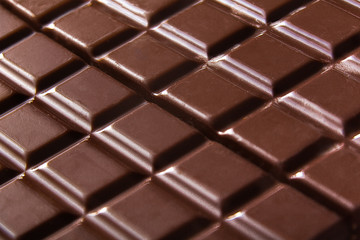 Pure chocolate bars, looking especially delicious. they are squared blocks shaped