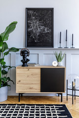 Modern scandinavian home interior with mock up poster frame, design wooden commode, lamp, flowers, decoration, plant , shelf and personal accessories in stylish home decor.