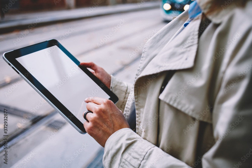 Poster Female person touching with finger blank screen of modern touch pad connected to 4G internet.Cropped view of blogger holding digital tablet with copy space display for advertise or website content