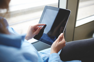 Closely image of woman`s finger is touching touch pad screen with copy space for your advertising...