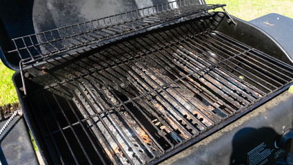 Empty grill ready for a grilling session with lots of grilled meats and foods
