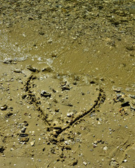 Heart being swept away at the beach
