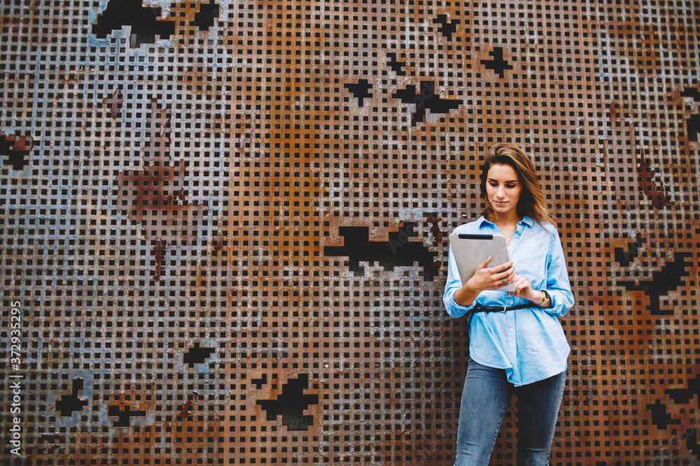 Aufkleber millennial hipster girl touching with finger on screen of modern touch pad while networking online, 