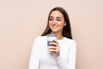 Young woman over isolated background holding coffee to take away