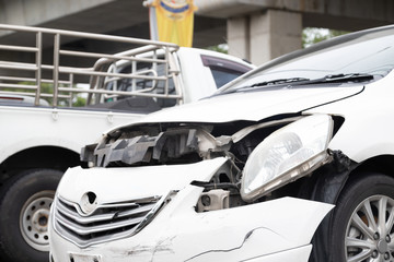Close-up of front of white car get damaged by accident on the road. concept of road safety