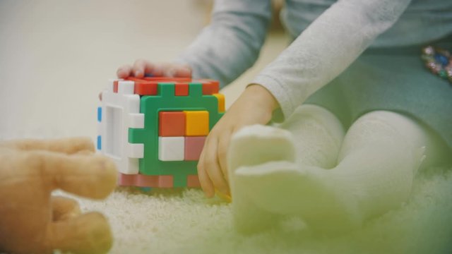 4k slowmotion video of girl on the floor playing.