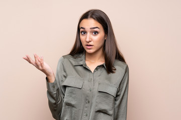 Young girl over isolated background making doubts gesture