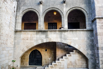 Fototapeta na wymiar stone architecture building with oval arches doors steps and staircase in rhodes