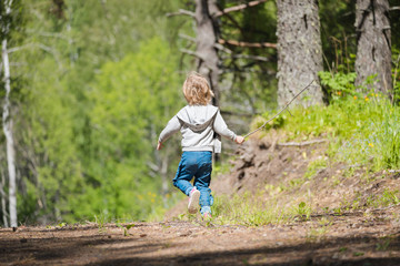 Beautiful baby walks and have fun in the forest.