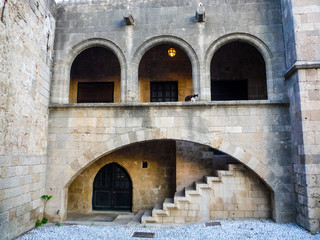 Fototapeta na wymiar stone architecture building with oval arches doors steps and staircase in rhodes