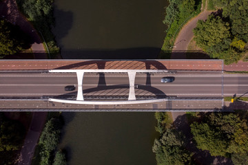 Top down aerial view showing a steel bridge construction asphalt road over the Twentekanaal in...