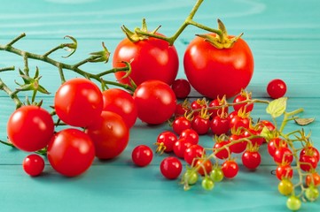 Freshly natural red tomatoes background. ripe tomato. Healthy eating and nutrition. natural raw fruits close up. Solanum pimpinellifolium (Lycopersicon pimpinellifolium), cherry and common tomatoes