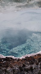 Abstract Blue Natural Rocky Spring with White and Brown Rocky Edge and Fog