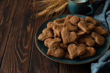 Homemade wholegrain cookies with oatmeal, raisin, nuts, seeds and milk on brown rustic wooden background. Healthy eating concept
