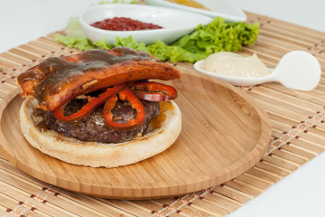Slice Of Hamburger Bun With Chorizo, meat, And Sauce; Ready To Assemble The Burger.