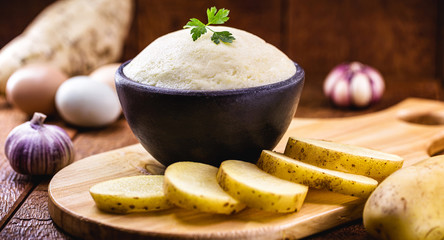 Brazilian mashed potato, on rustic background on wooden table. Organic product.