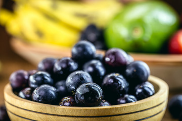 Jaboticaba or jabuticaba, Brazilian and South American fruit, in a rustic wooden basket. Fruit used in sweets, jellies, drinks and medicinal use.