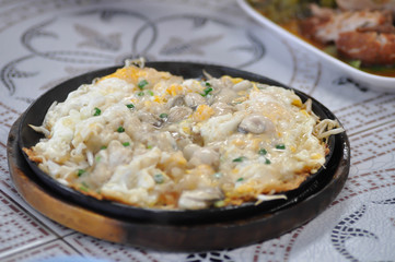 Oyster omelette or stir fried Oyster with egg and vegetable, shell omelet