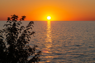 Orange sunset over calm water