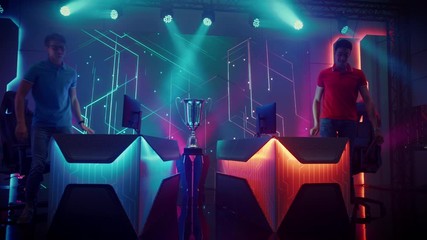 Two Professional eSports Gamers Finish Video Games Match, do Postgame Goodwill Handshake, Hug and Wave to Audience after Competitive Battle on Championship Event. Cyber Tournament. Slow Motion 