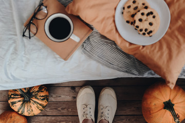 Morning concept. Breakfast in bed. Cozy autumn homely scene with pumpkins. Flat lay, top view. Home decor. Morning before Halloween or Thanksgiving day.