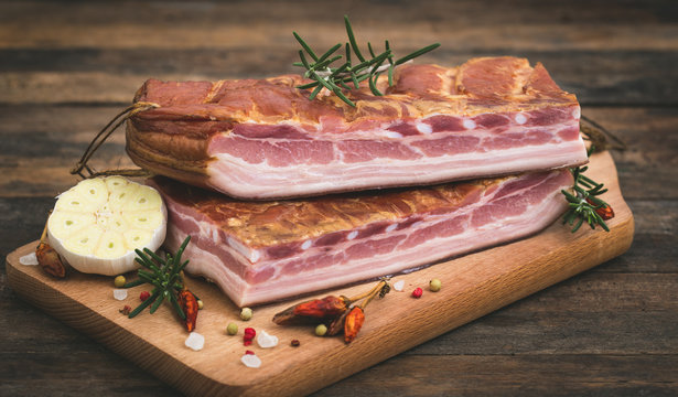Fresh smoked bacon on wooden board