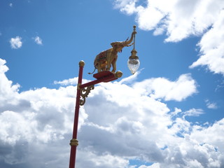 ligth pole a little elephant with blue sky