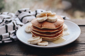 Delicious pancakes topped with banana and honey. Homemade classic american pancakes. Breakfast in the morning. 
