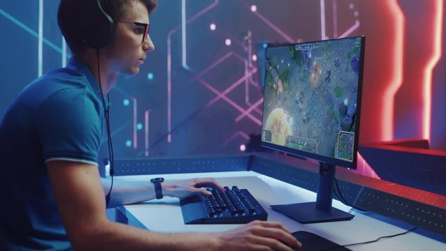 Professional eSports Gamer Plays RPG MOBA Mock-up Video Game with Super Action and Fun Special Effects on His Personal Computer, Talks to Teammates using Headset