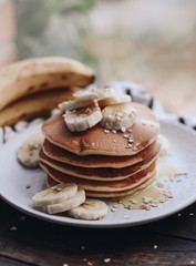 Delicious pancakes topped with banana and honey. Homemade classic american pancakes. Breakfast in the morning. 