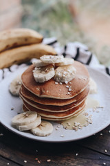 Delicious pancakes topped with banana and honey. Homemade classic american pancakes. Breakfast in the morning. 