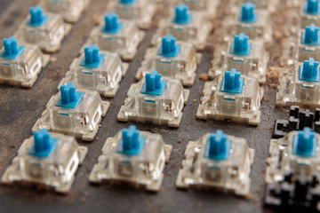 very dirty keyboard. Cat hair, bread crumbs and dust have accumulated under the keys. Mechanical keyboard switches close up.
