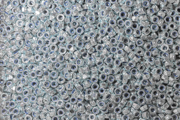 Nuts. Texture. A lot of rubberized nuts for bolts and screws. Background for wallpaper. Female screw. Screw-nut. Internal screw.