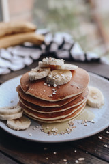 Delicious pancakes topped with banana and honey. Homemade classic american pancakes. Breakfast in the morning. 