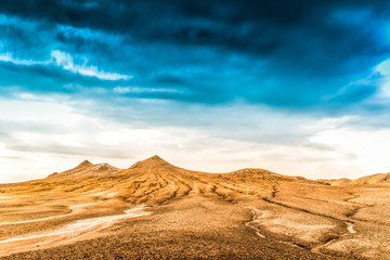 Fototapeta na wymiar sand dunes in the desert covered by light blue sky. storming over the dessert