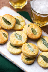 Salty shortbread cookies with sage and beer on a wooden stool.
