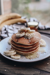 Delicious pancakes topped with banana and honey. Homemade classic american pancakes. Breakfast in the morning. 