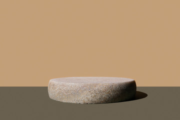 Granite pedestal on slate gray, beige background. Monochrome brown banner, poster. Mockup for...
