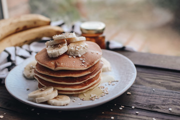 Delicious pancakes topped with banana and honey. Homemade classic american pancakes. Breakfast in the morning. 