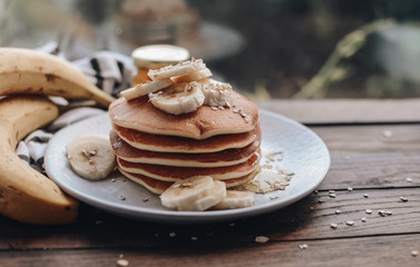 Delicious pancakes topped with banana and honey. Homemade classic american pancakes. Breakfast in the morning. 