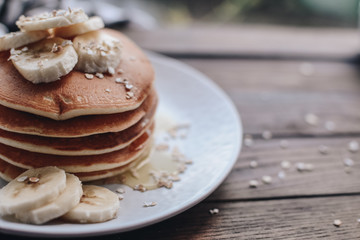 Delicious pancakes topped with banana and honey. Homemade classic american pancakes. Breakfast in the morning. 