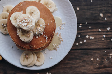 Delicious pancakes topped with banana and honey. Homemade classic american pancakes. Breakfast in the morning. 