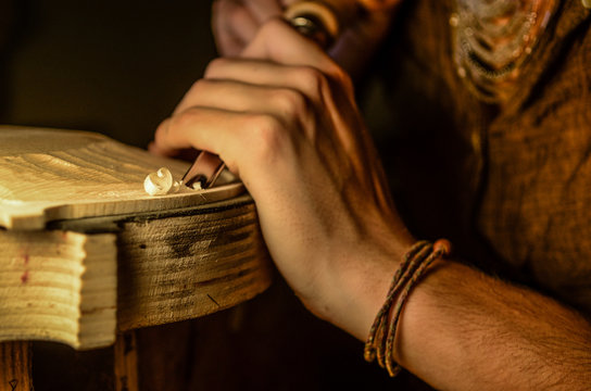 Artisan woman violin maker luthier working in a new violin