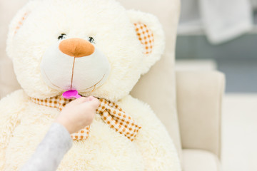 Studio portrait of a cute teddy bear for kids with happy smiling facial expression.