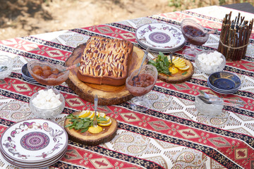 Fototapeta na wymiar Breakfast table with apple pie, tea glass, outdoors. Homemade Apple Pie