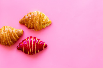 Set of croissants - berry, classic - on pink background top view